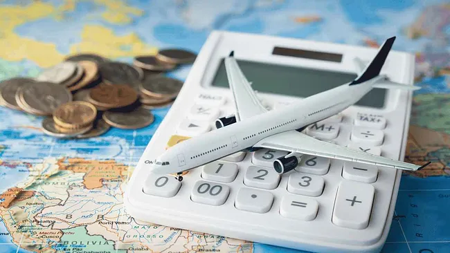 Picture of calculator and map while someone calculates travel costs to Australia